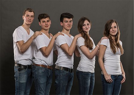 Five teenagers standing together with hands on shoulders Stock Photo - Premium Royalty-Free, Code: 649-06844562