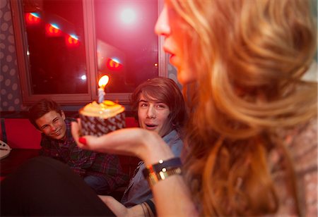 Teenage girl blowing out candle on birthday cake Stock Photo - Premium Royalty-Free, Code: 649-06844694