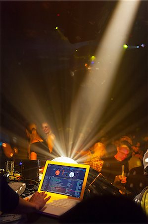 dj woman - Nightclub scene with people dancing, disc jockey mixing desk with computer Stock Photo - Premium Royalty-Free, Code: 649-06844744