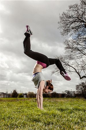 Woman doing handstand with legs apart Stock Photo - Premium Royalty-Free, Code: 649-06844941