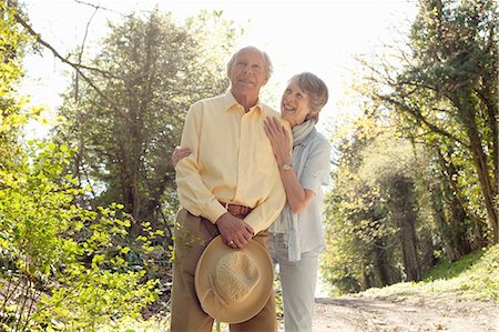 senior couple healthy - Wife posing with husband holding her straw hat Stock Photo - Premium Royalty-Free, Code: 649-06844950