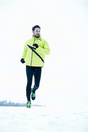 running in field - Man snow running Stock Photo - Premium Royalty-Free, Code: 649-06844985