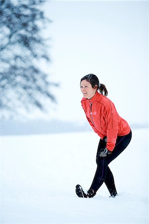 Woman stretching before snow run Stock Photo - Premium Royalty-Free, Code: 649-06844997