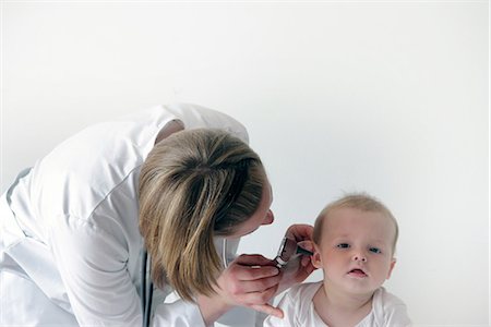 doctor patient consultation - Female doctor examining baby's ear Stock Photo - Premium Royalty-Free, Code: 649-06845233