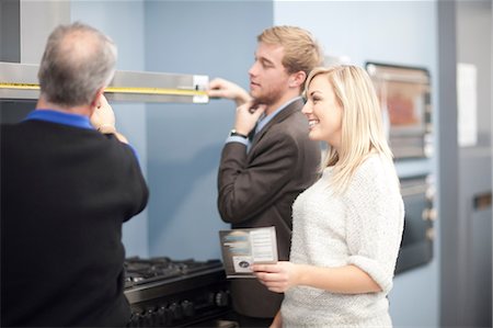 simsearch:649-07119168,k - Young couple looking at ovens in showroom Stock Photo - Premium Royalty-Free, Code: 649-07064073