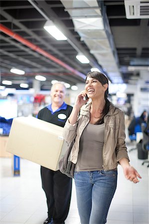 diy or home improvement - Woman leaving showroom with purchase Stock Photo - Premium Royalty-Free, Code: 649-07064088