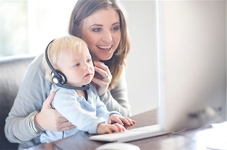 Mother and baby boy looking at computer screen Stock Photo - Premium Royalty-Free, Code: 649-07064181