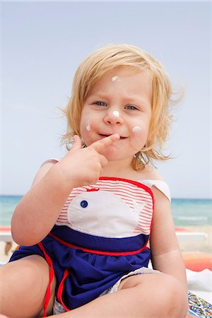 funny baby - Baby girl with suncream on face Stock Photo - Premium Royalty-Free, Code: 649-07064522