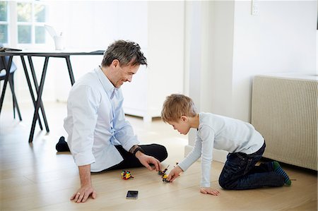 Father and son playing with toys Stock Photo - Premium Royalty-Free, Code: 649-07064553