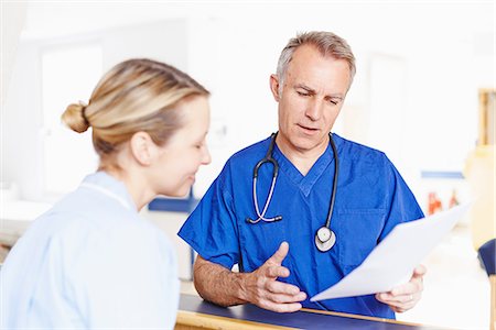 simsearch:649-07064718,k - Doctor and nurse looking at notes Stock Photo - Premium Royalty-Free, Code: 649-07064689