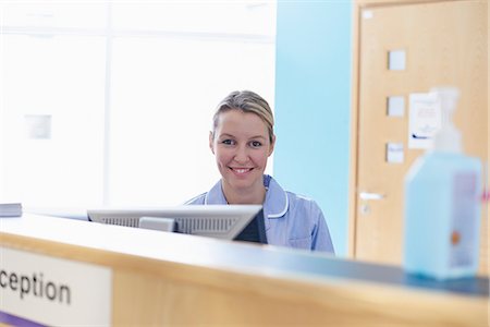 Nurse sitting at reception desk Stock Photo - Premium Royalty-Free, Code: 649-07064682