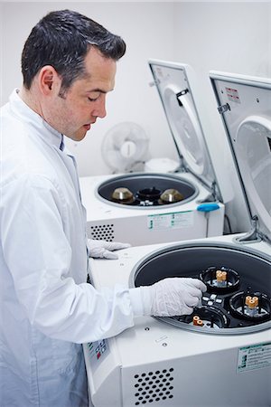 Man putting vials into centrifuge Stock Photo - Premium Royalty-Free, Code: 649-07064747