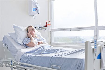 Patient lying on hospital bed on telephone call Stock Photo - Premium Royalty-Free, Code: 649-07064764