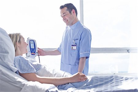 patient and care - Nurse taking patient's blood pressure Stock Photo - Premium Royalty-Free, Code: 649-07064767