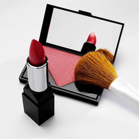 Rouge and lipstick with make up brush Stock Photo - Premium Royalty-Free, Code: 649-07065003