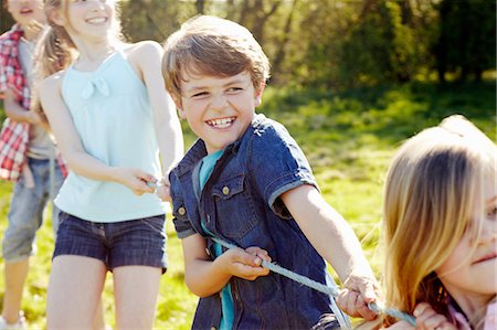 Close up of group of children playing tug o war Stock Photo - Premium Royalty-Free, Code: 649-07063046