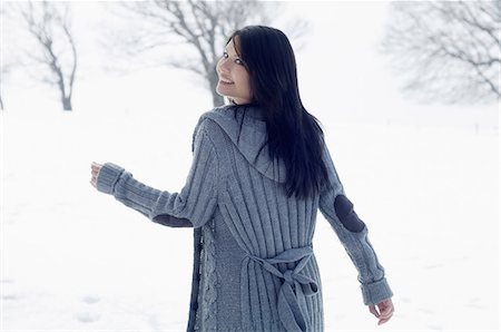 Young female walking in snowy field Stock Photo - Premium Royalty-Free, Code: 649-07063059