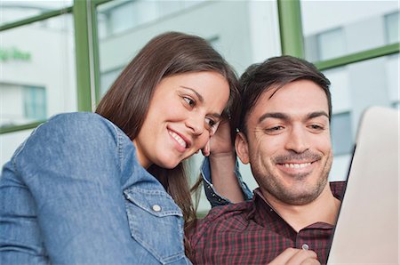 denim shirt - Happy young couple looking at digital tablet Stock Photo - Premium Royalty-Free, Code: 649-07063157