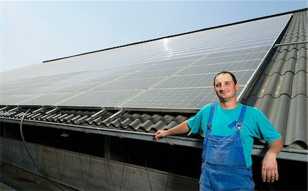 solar energy - Portrait of farmer with solar panels on barn roof, Waldfeucht-Bocket, Germany Stock Photo - Premium Royalty-Free, Code: 649-07063479