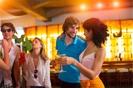 flirting - Group of friends with cocktails in bar Stock Photo - Premium Royalty-Free, Code: 649-07063537