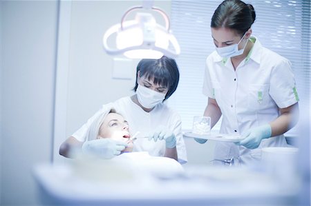 dentist (female) - Dentist and nurse treating patient Stock Photo - Premium Royalty-Free, Code: 649-07063590