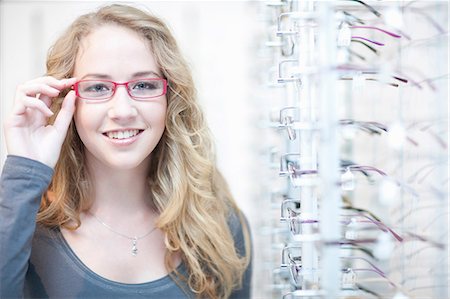 eye wear - Young woman trying on eyeglasses Stock Photo - Premium Royalty-Free, Code: 649-07063759