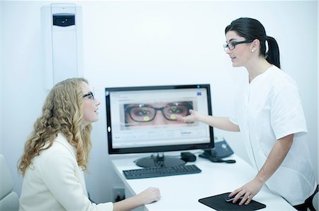 simsearch:649-07063763,k - Optician guiding patient on choice of eyeglasses Stock Photo - Premium Royalty-Free, Code: 649-07063786