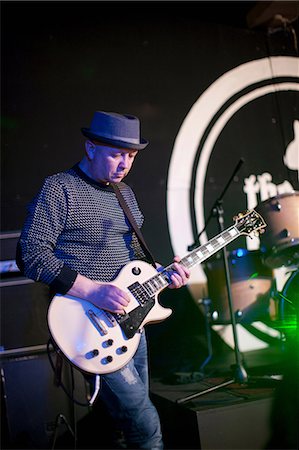 spotlight (beam of light) - Mature man playing guitar on stage Stock Photo - Premium Royalty-Free, Code: 649-07063886