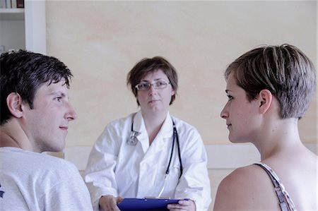 Doctor talking to young couple Stock Photo - Premium Royalty-Free, Code: 649-07118276