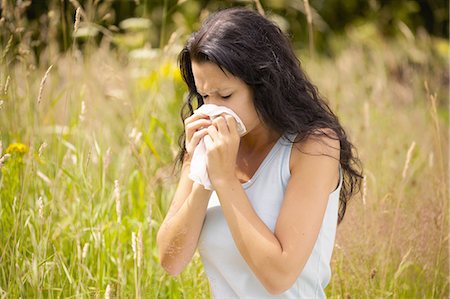 Girl wiping nose with tissue Stock Photo - Premium Royalty-Free, Code: 649-07118283