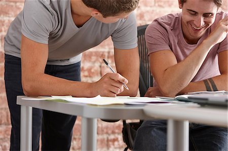 designer (interior, male) - Two male colleagues, one making notes Stock Photo - Premium Royalty-Free, Code: 649-07118345