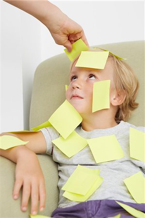 self adhesive note - Hand sticking adhesive notes on boy Stock Photo - Premium Royalty-Free, Code: 649-07118386