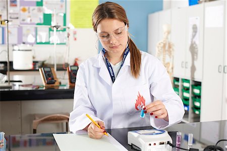 simsearch:649-07118434,k - Lab technician holding chemical sample and making notes Stock Photo - Premium Royalty-Free, Code: 649-07118425