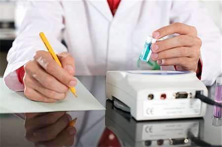simsearch:649-07118434,k - Lab technician holding chemical and making notes Stock Photo - Premium Royalty-Free, Code: 649-07118427
