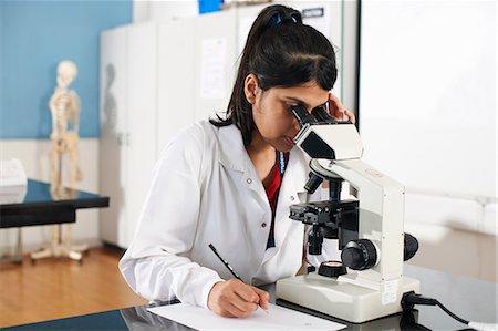 simsearch:649-07118434,k - Chemistry student using microscope in laboratory Stock Photo - Premium Royalty-Free, Code: 649-07118421