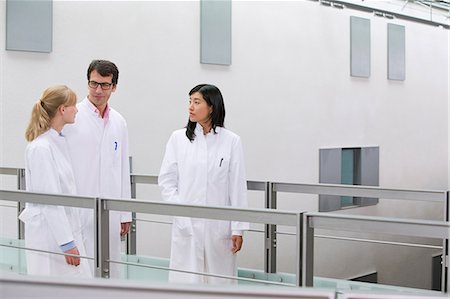 simsearch:685-02938374,k - Group of  scientists talking in atrium Stock Photo - Premium Royalty-Free, Code: 649-07118841