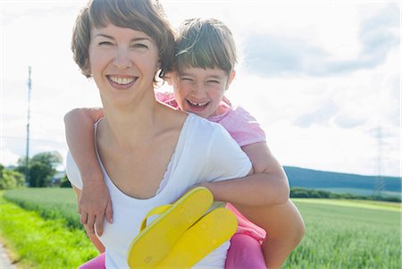 piggyback on mom - Mother giving piggyback to daughter Stock Photo - Premium Royalty-Free, Code: 649-07118986