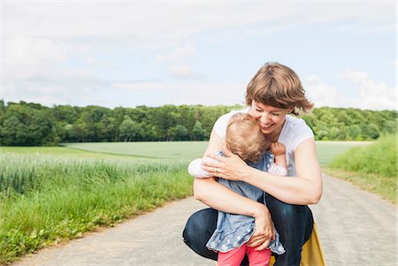 safety family - Mother hugging daughter on country road Stock Photo - Premium Royalty-Free, Code: 649-07118980