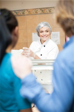 photo of grocery clerk - Young sales assistant at counter Stock Photo - Premium Royalty-Free, Code: 649-07119165