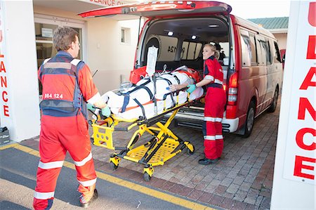 Paramedics lifting patient from ambulance Stock Photo - Premium Royalty-Free, Code: 649-07119223