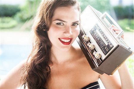 red music - Young woman holding vintage radio Stock Photo - Premium Royalty-Free, Code: 649-07119500