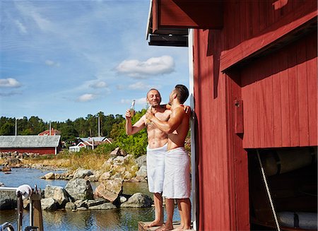 Two men with beers outside sauna Stock Photo - Premium Royalty-Free, Code: 649-07238977