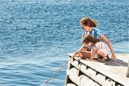 family photo on a dock - Mother and daughter with fishing net, Utvalnas, Gavle, Sweden Stock Photo - Premium Royalty-Free, Code: 649-07238979