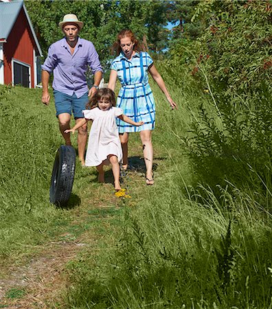simsearch:649-07437620,k - Parents and girl rolling tyre on path, Utvalnas, Gavle, Sweden Stock Photo - Premium Royalty-Free, Code: 649-07238984