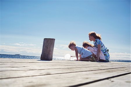 parents children nature - Mother and daughters playing on jetty, Utvalnas, Gavle, Sweden Stock Photo - Premium Royalty-Free, Code: 649-07238997