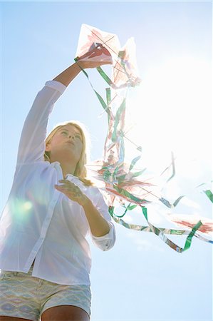 summer picture with kite - Young woman holding kite, Utvalnas, Gavle, Sweden Stock Photo - Premium Royalty-Free, Code: 649-07239004