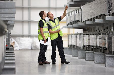 Warehouse workers checking shelves in engineering warehouse Stock Photo - Premium Royalty-Free, Code: 649-07239382