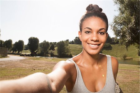 park woman fun - Young woman taking a picture of herself Stock Photo - Premium Royalty-Free, Code: 649-07239426