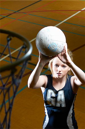 simsearch:649-07239531,k - Netball player aiming at goal Stock Photo - Premium Royalty-Free, Code: 649-07239517