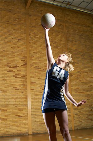 simsearch:649-07239531,k - Portrait of netball player reaching for ball Stock Photo - Premium Royalty-Free, Code: 649-07239513